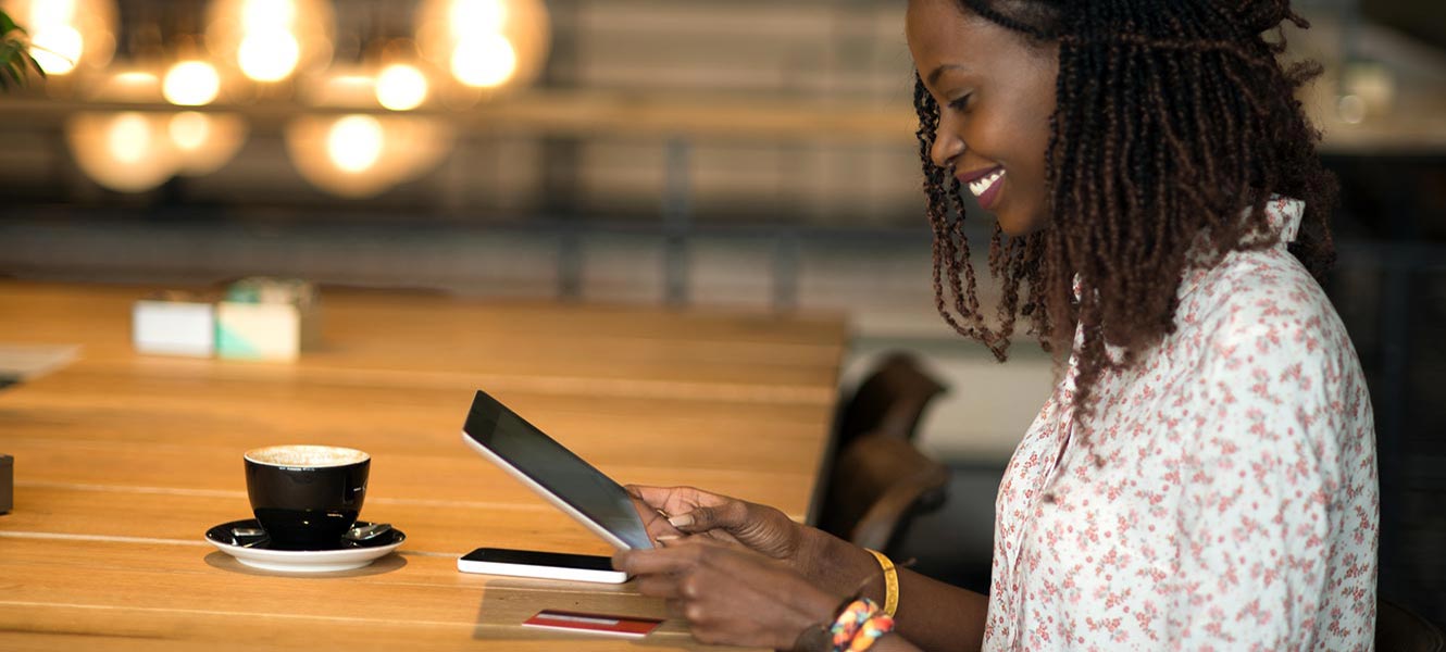 Young woman using tablet in coffee shop