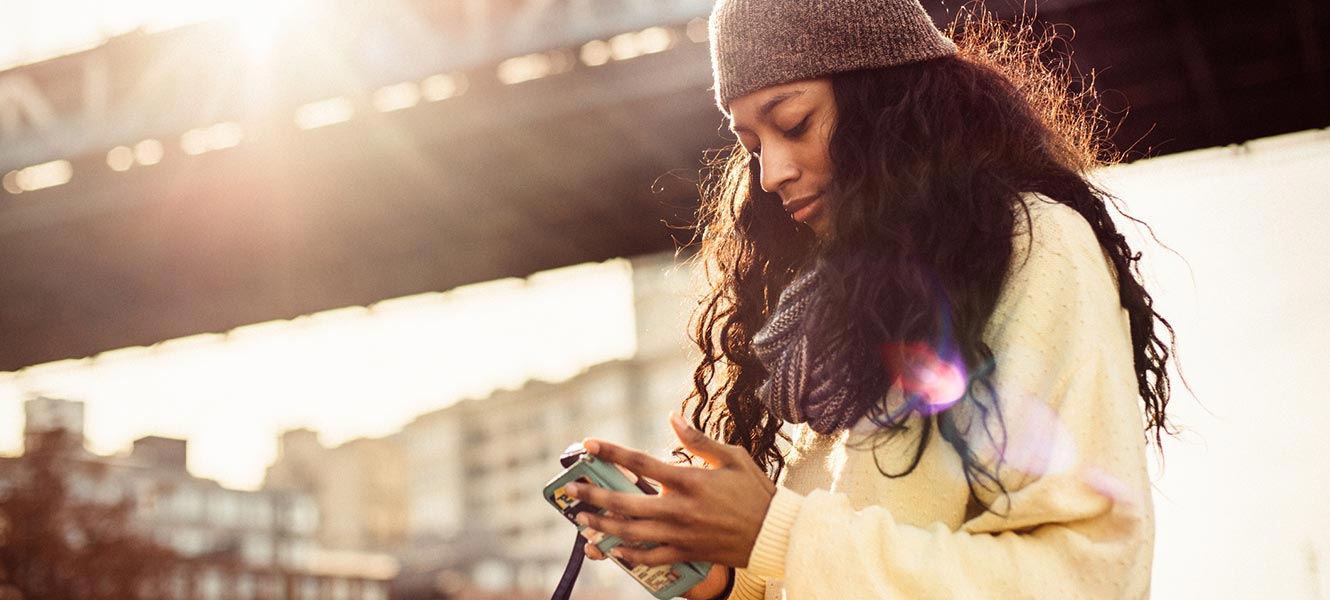 Woman using phone outdoors