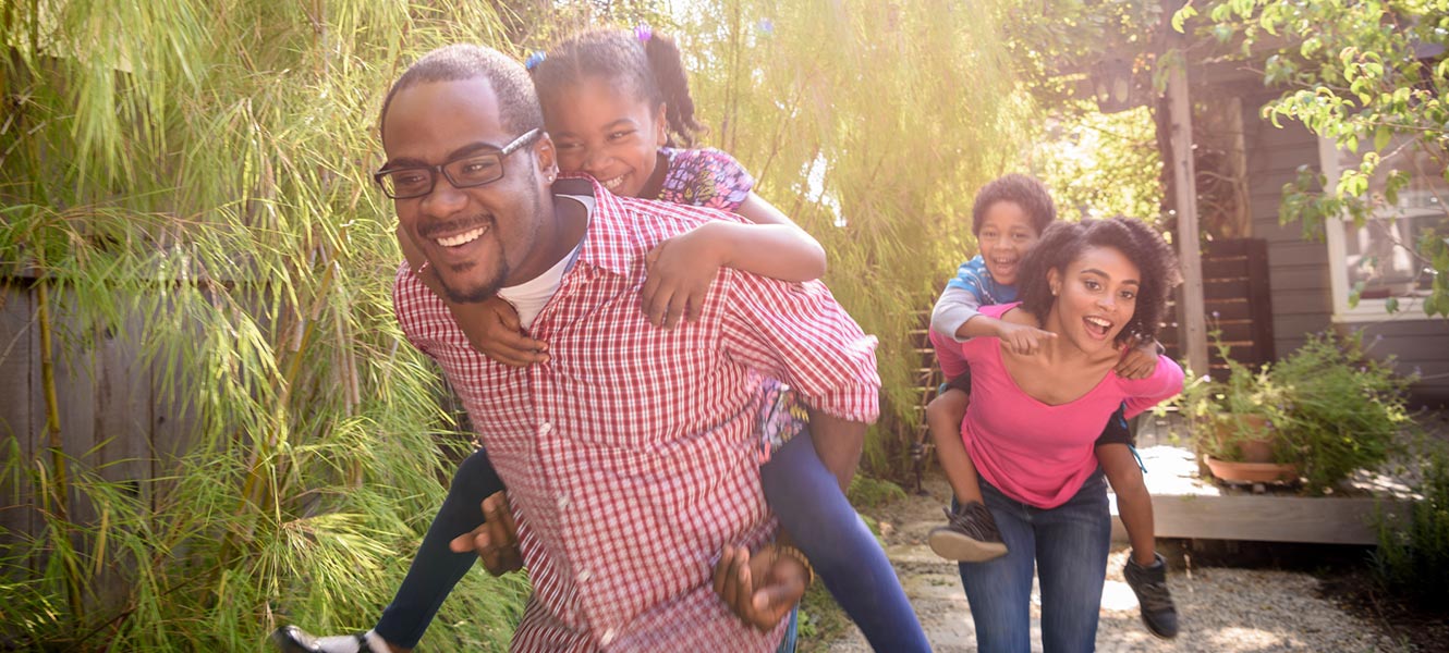 Young family playing in back yard