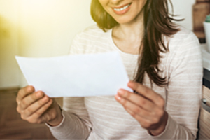 Happy woman looking at check or bill