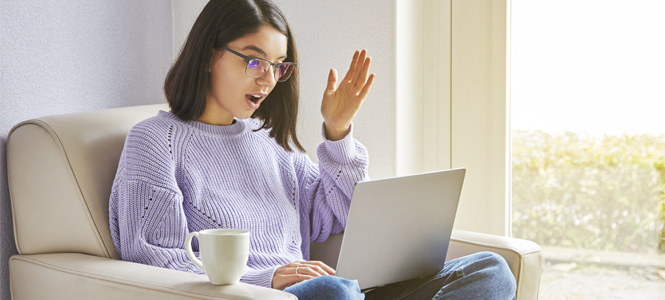 Woman looking at laptop screen with surprised look.