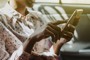 Woman in back seat of car on phone