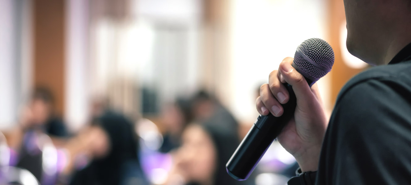 Man announcing at a meeting.