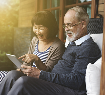 Couple looking at the ipad together.