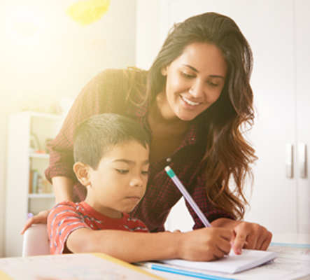 woman helping son with homework in home